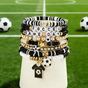 Detail showing soccer-themed beaded bracelets with SOCCER charms and jersey pendant