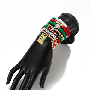 Detail of soccer themed beaded bracelet set with jerseys and soccer shoe charms