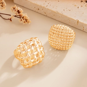 Detail view of woven texture and beaded golden rings on travertine decorative stone