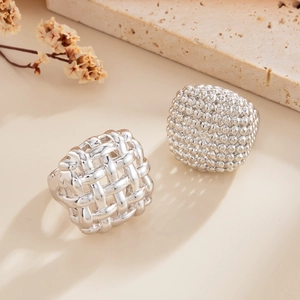 Silver woven hollow ring set with geometric spherical texture in modern metallic style