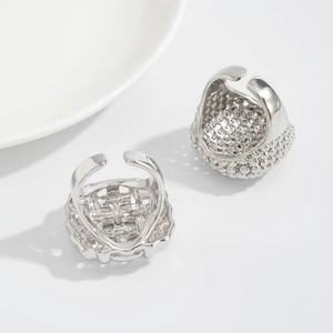 Detailed shot of two vintage silver mesh rings with textured weave and beaded patterns