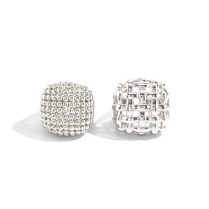 Macro detail of silver CCB beads with textured grains and woven metallic hollow structure