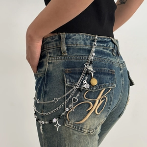Punk style multi-layered silver pant chain with star charms and beads on denim jeans