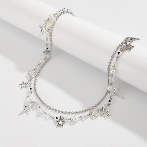 Detail of punk style silver chain belt with star pendants, pearls and heart beads
