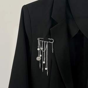 Silver punk pin brooch with fringe chains pearls and star charms on black blazer lapel