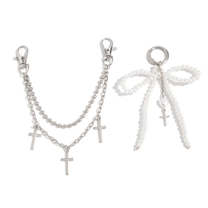 Close-up of hip hop silver metal chain with crosses and pearl bow bag pendant
