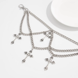 Detail of silver multilayer chain bag charm with vintage cross pendants and lobster clasp