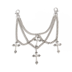 Detail of silver gothic multi-layered metal chain featuring vintage cross pendants