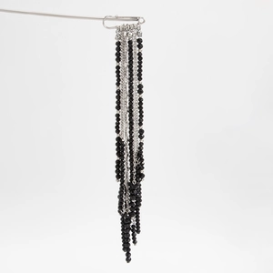 Detail of hip-hop crystal beaded fringe brooch with black faceted beads and silver chains