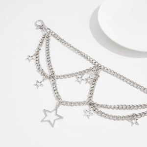Close-up of multi-layer silver metal chain with hollow star pendants and lobster clasp