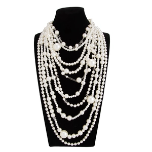 Detail of layered baroque pearl necklace showing gradient pearl sizes and metallic clasps