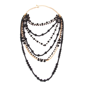 Elegant multi-layered black pearl necklace set with gold chains in a luxury stacked design