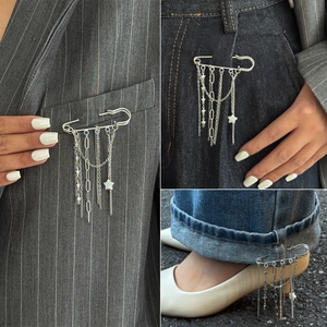Silver star tassel brooch with metal chains shown on blazer, pocket, and trouser hem