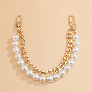 Detail of double-layered bag chain with white pearls and gold metal links and hooks