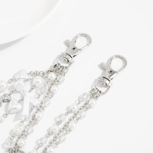 Multilayer beaded bag chain with pearls, metal hearts, crystals and a white bow knot