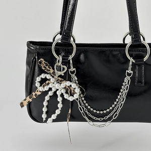 Glossy black handbag with leopard bow pearl charm and silver chain tassels