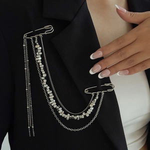 Silver multi-layer chain brooch with metal pins on black suit lapel detail