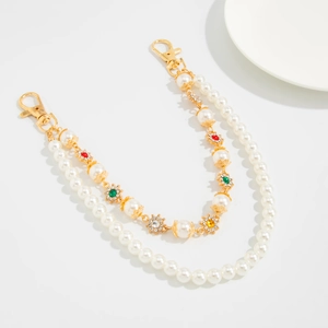 Close-up of double-layer pearl bag chain with colorful rhinestone flower accents