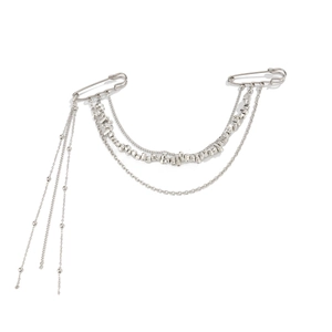 Detailed view of silver layered chain brooch with tassels and safety pin design