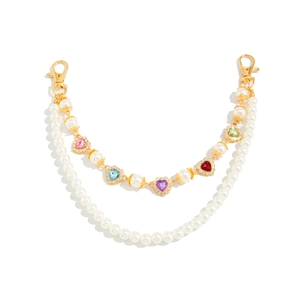 Double-layered pearl bag chain with colorful diamond-encrusted heart charms and gold clasps