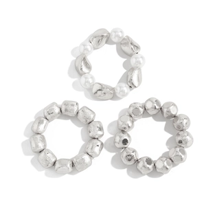 Detailed view of elastic liquid metal style beaded rings with silver beads and pearls