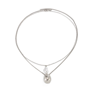 Macro shot of double-layer necklace with baroque pearl and oval silver drop pendant