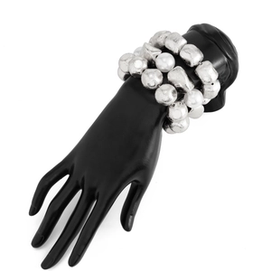 Detail of three-layer beaded bracelet featuring silver irregular beads and white pearls