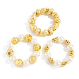 Detailed set of elastic resin bracelets with gold textured beads and faux pearls
