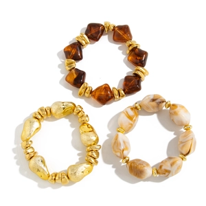 Three-piece set of irregular resin bracelets with amber, cream marble, and gold beads