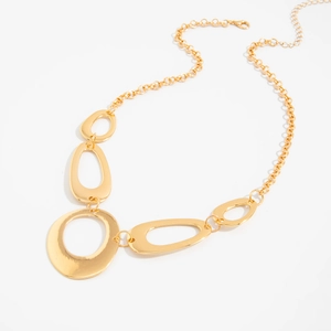 Detailed close-up of golden O-ring metal belt with hollow geometric links and clasp