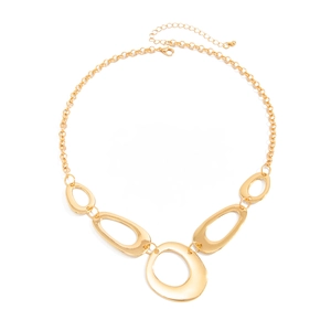 Detailed macro view of the irregular hollow gold oval links on the metallic necklace