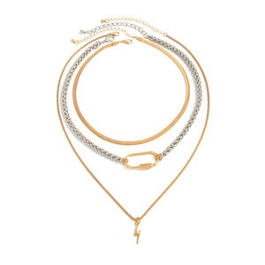 Detailed view of layered necklaces with gold snake chain, silver lock, and lightning pendant