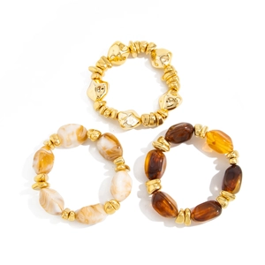 Detailed view of beaded elastic bracelets with gold CCB and marble resin beads