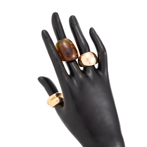 Detail of cross rings set with amber resin and polished wide gold metal bands