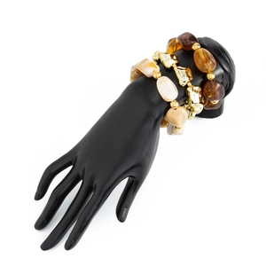 Detail of amber and gold resin beaded elastic bracelets on a black hand model display