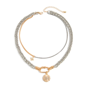 Detail of layered gold and silver mixed chains with star pendant and sunburst charm