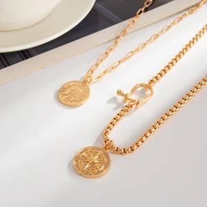 Detail of vintage gold-plated necklaces with U-shaped horseshoe buckle and star pendant