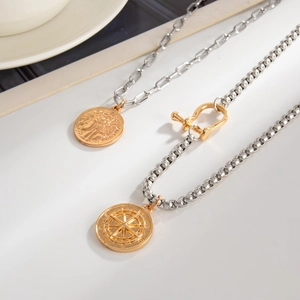 Detail of horseshoe clasp chain and vintage coin star pendant in mixed metal colors