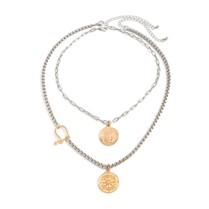 Detail of double-layered silver chain necklace with gold coin and compass pendants