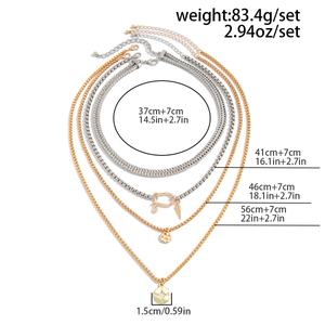 Detailed view of layered snake chain necklace with compass pendant and size markings