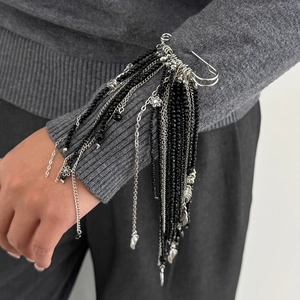 Détail d'une broche épingle gothique avec perles noires et pendentifs en forme de cœur