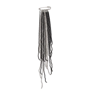 Detailed view of long beaded tassel brooch with silver pin and black crystal beads