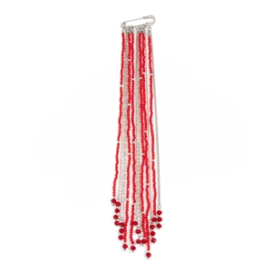 Detail of a silver safety pin brooch with hanging red bead fringe and metallic chains