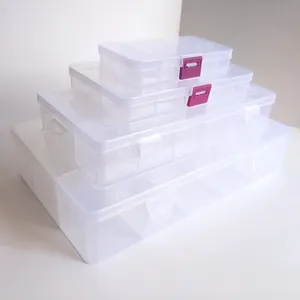 Macro view of clear plastic organizer boxes with adjustable grids and snap-on lids