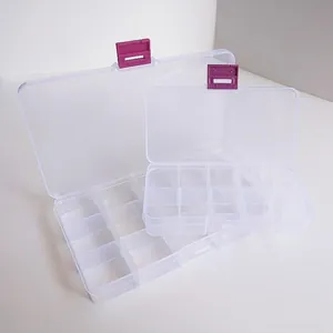 Detail of transparent plastic organizer boxes with adjustable grids and purple safety buckles