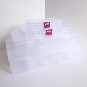 Stack of clear plastic organizer boxes with multi-compartments and secure snap buckles
