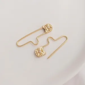 14K gold plated safety pin pendant with embossed cross floral pattern and zircon