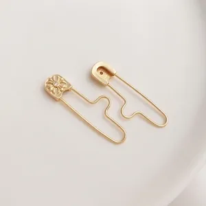 14K gold plated safety pin pendant with carved sunflower relief and cubic zirconia stone