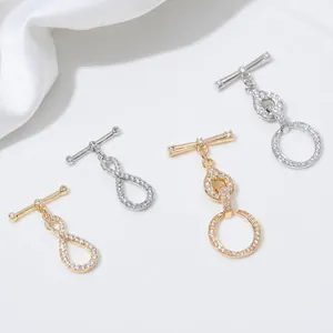 Micro-paved zircon infinity symbol and round toggle clasps in 14K gold and silver finish