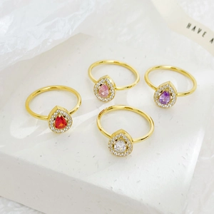 Elegant gold rings featuring pear-cut teardrop zircons in red, pink, purple, and clear white